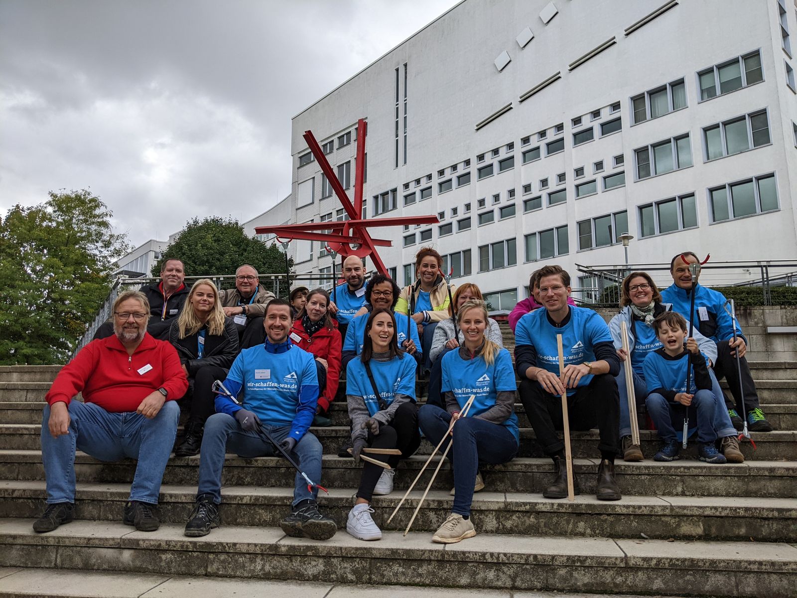 Group of people holding tools in their hands.