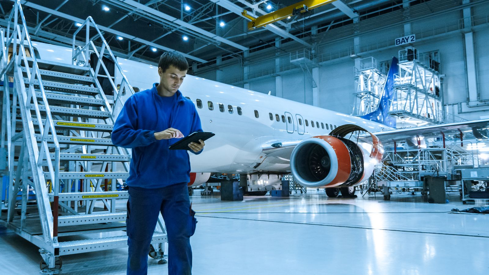 1161854080 Aircraft,Maintenance,Mechanic,In,Blue,Uniform,Is,Going,Down,The