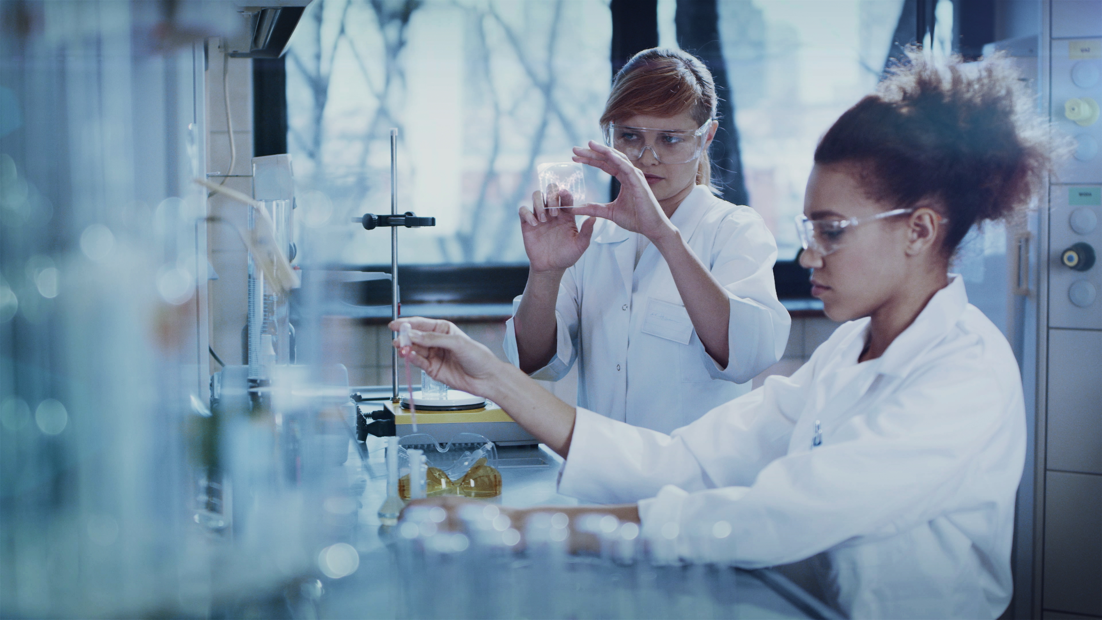 Multi ethnic female team studying DNA mutations. Virtual touch screens